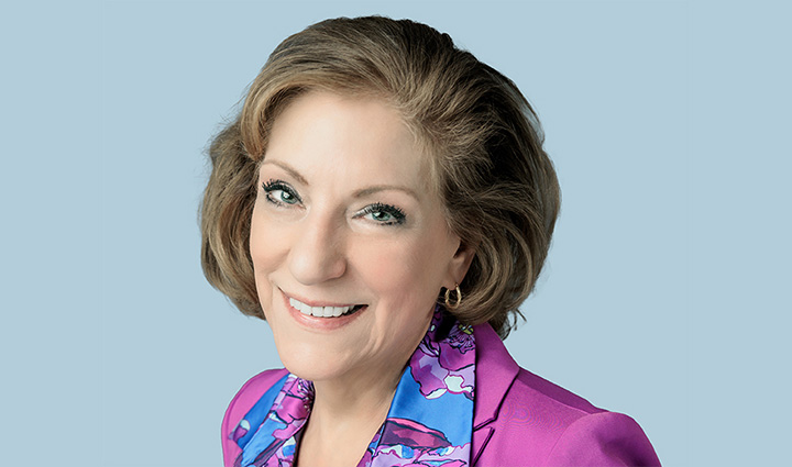 Headshot of WWP Board Director Kathy Hildreth over a light blue background. 