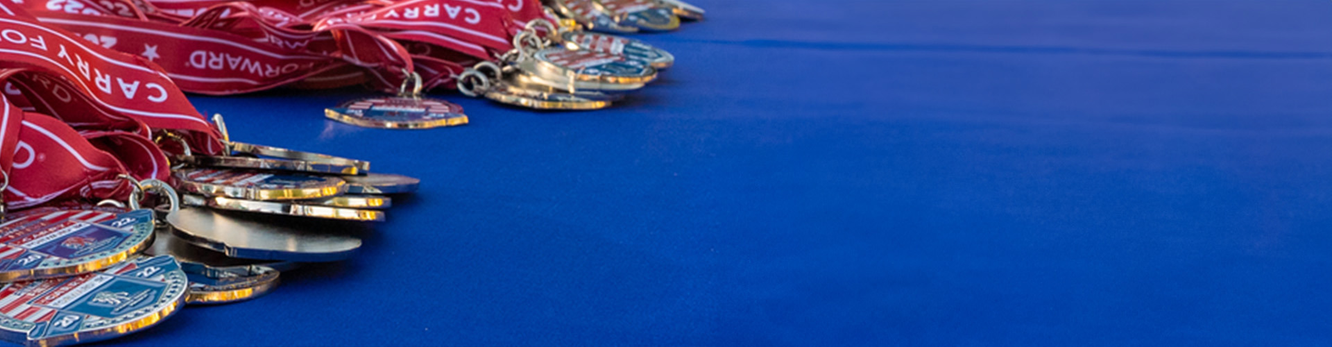 Carry Forward 5K medals displayed on a table
