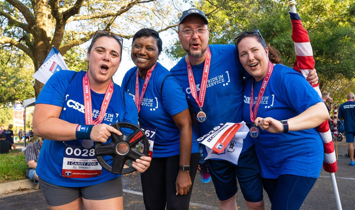 Carry Forward 5K participants posing with their medals.