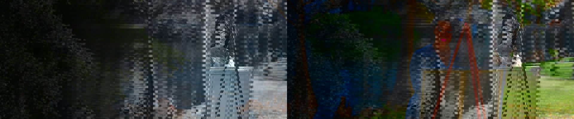 Wounded warrior Yomari Cruz painting outside near water