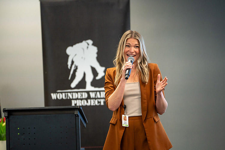 WWP teammate speaking to crowd on microphone.