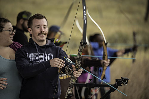 Zach Tidwell doing archery
